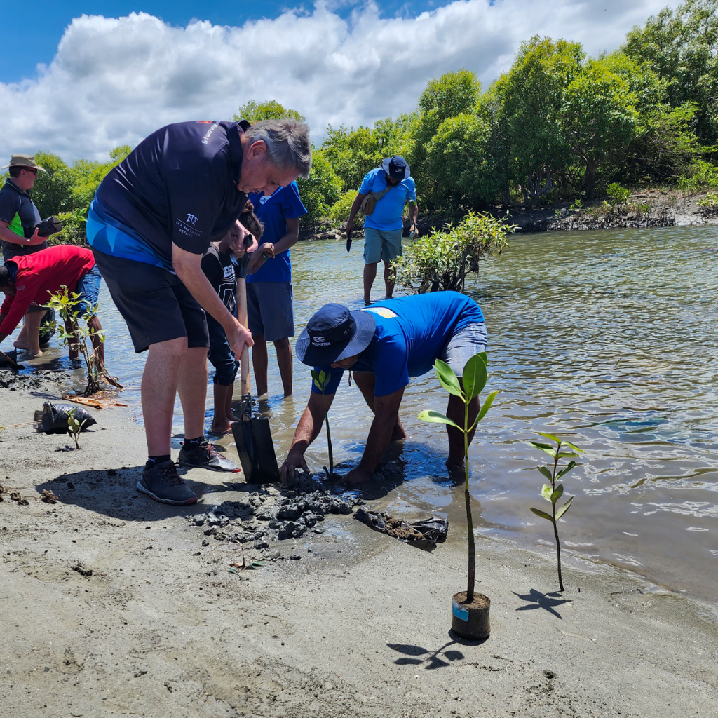 Credit Corporation staff planting mangroves at Gaire, Central Province.