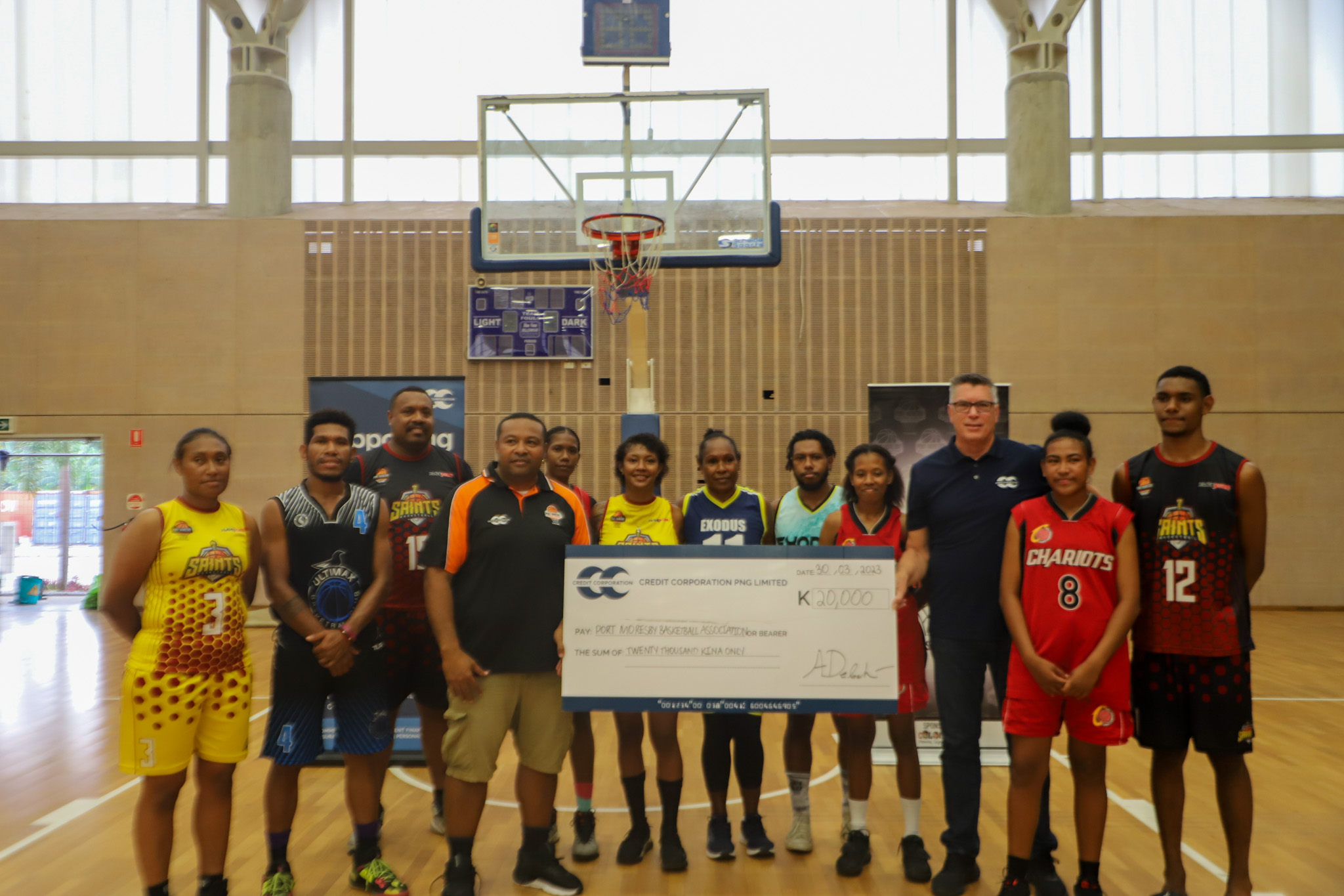 Credit Corporation Group CEO, Danny Robinson (third right) and POMBA Vice President Lahari (left) with players from the POMBA competition.